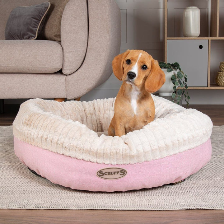 Scruffs Ellen Donut Dog Bed combines stylish design, plush comfort, and eco-friendly features with recycled polyester filling. The machine washable design adds practicality for pet owners.Pink