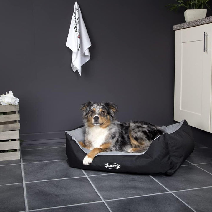 Elevate your pet's comfort with the Scruffs Expedition Box Dog Bed, designed to withstand the rigors of outdoor adventures while maintaining a stylish edge. Graphite